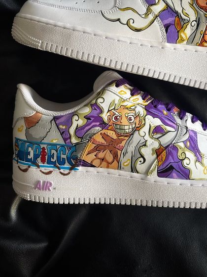 Detailed view of the other side of the Luffy Gear 5 sneaker, highlighting the dynamic artwork and purple accents.