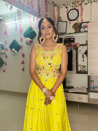 A full-length view of the Haldi bride in her bright yellow lehenga.