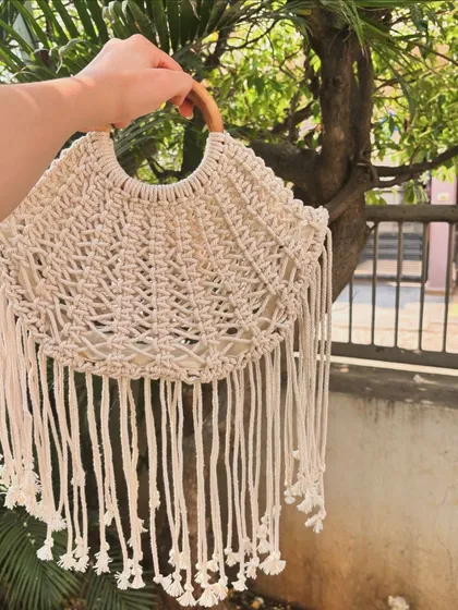 Our macrame half-moon shaped bag with long fringes. This is a true boho statement piece, perfect for festivals or a beach day. It's available in over 12 different colors.