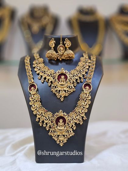 A stunning temple jewellery set with rich red stones, featuring a choker and a matching long necklace.