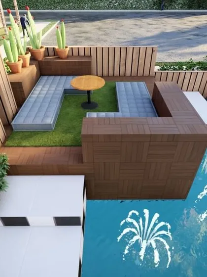 A cozy seating nook on a terrace next to a swimming pool. The design uses built-in wooden benches and planters to create a comfortable and stylish area for poolside relaxation.