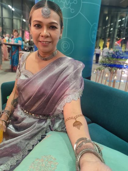 This lovely lady is all dressed up for a party, and her simple arm mehendi adds the perfect festive touch. This shows how a small design can complete a look.