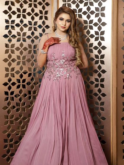 A full-length shot of the pink gown, showing its elegant and flowing silhouette.