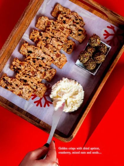 An overhead view of our festive cheese board, featuring Fruit 'N' Nut Crisps and two types of cheese.