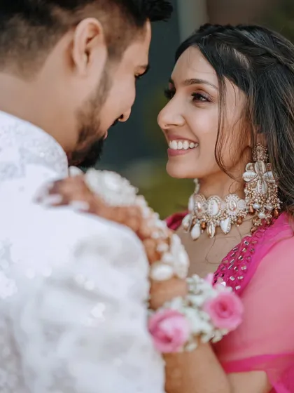 A close-up shot focusing on the bride's joyful expression as she looks at her partner. Capturing these loving glances is key to our candid photography style.