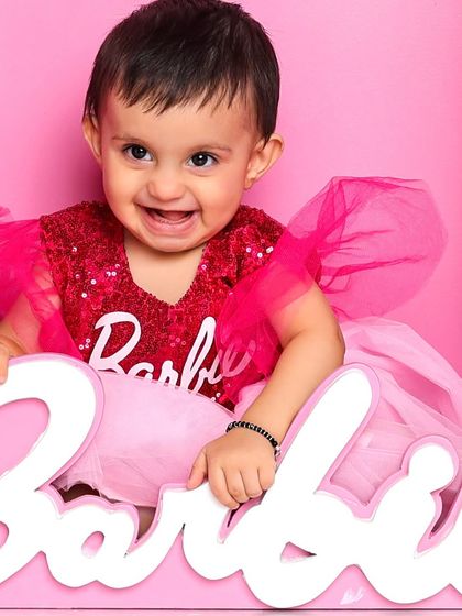 A close-up of our real-life Barbie. Her happy, laughing face popping out of the box is a moment of pure, infectious joy.