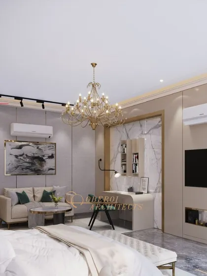 This elegantly designed bedroom features a chic chandelier, a cozy seating area, and a dedicated workspace, all exuding a sophisticated and inviting atmosphere.