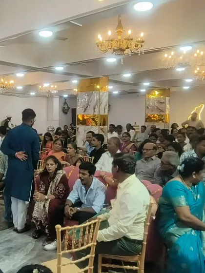 A candid shot of guests seated and enjoying a function in our Kalyan hall. The space is comfortable and well-lit, making it ideal for family gatherings.