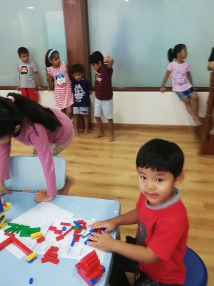 A young student focused on his LEGO creation. We provide a rich environment with plenty of materials for kids to explore their creativity.