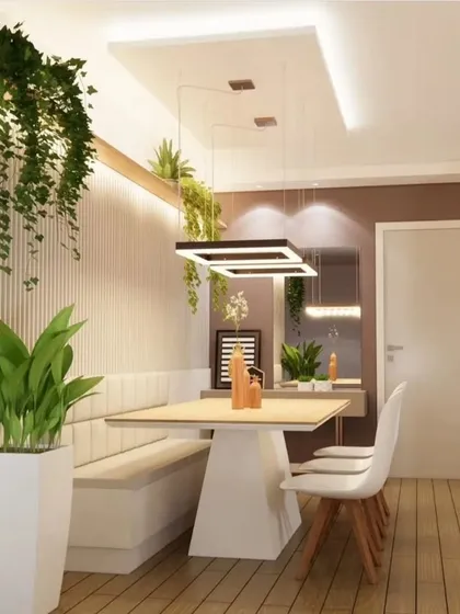 Another view of the bench-style dining area, showing the full length of the table and the modern chairs. This setup is perfect for saving space while providing ample seating.