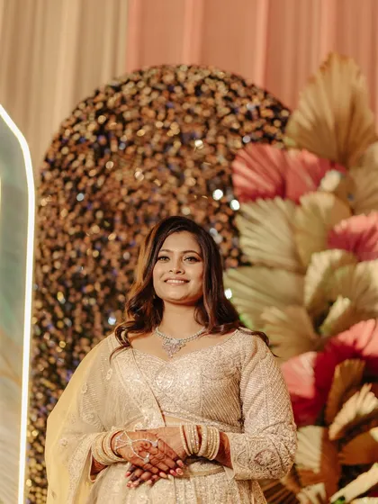 A candid moment showing the bride's radiant sangeet look. The makeup is designed to look flawless from every angle, ensuring she looks perfect in all her photos.
