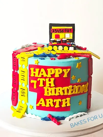 A closer look at the Timezone gaming cake, highlighting the bold colors and playful fondant decorations that capture the excitement of an arcade.