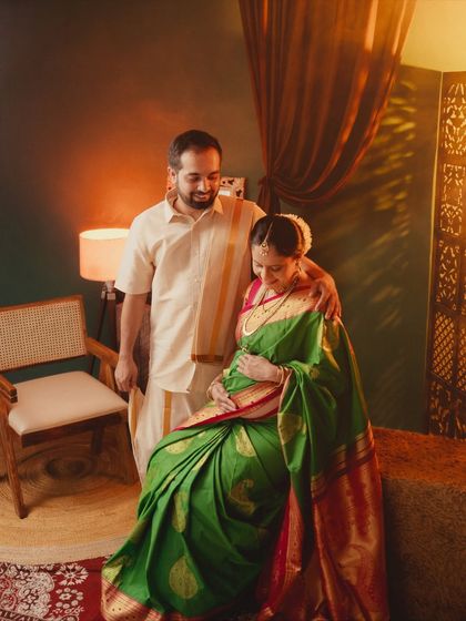 A warm and intimate couple portrait. The soft lighting and close framing create a sense of love and togetherness in this traditional maternity shoot.
