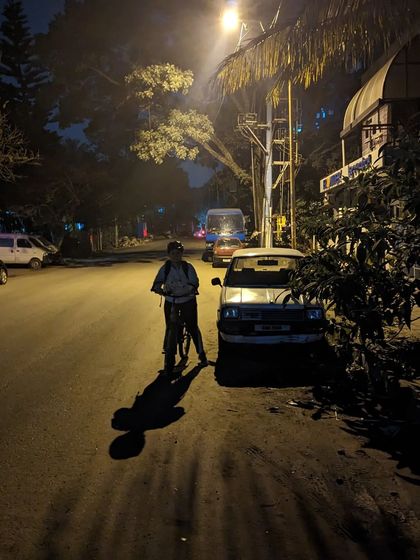 A rider pauses next to a classic Maruti Omni. Our slow-paced rides give us plenty of time to appreciate the little details and nostalgic sights around the city.