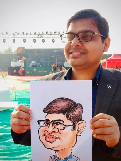Exaggerated? Yes. Accurate? Even more. This guest is holding his colorful caricature at an outdoor event.