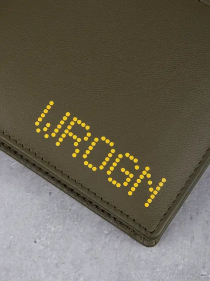 A close-up of the yellow dotted 'WROGN' logo on the olive wallet.