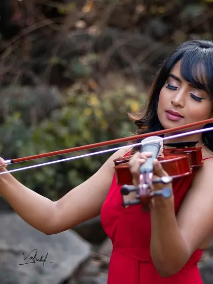 A close-up of the musician, capturing the serene expression as she plays. This shot from the 'girl with violin' series focuses on the emotion and artistry of the performance.