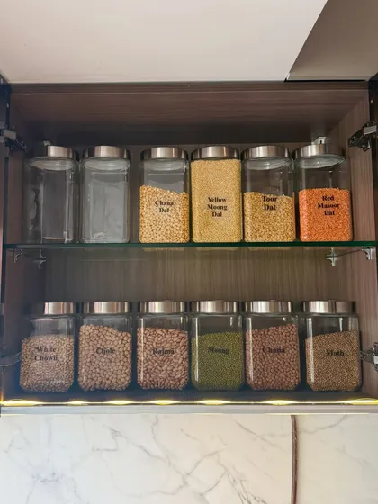 This cabinet is dedicated to dals and pulses, essential in any Indian kitchen. We arranged them by type and color, making it visually appealing and highly practical for daily cooking.