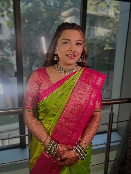 A stunning bride-to-be glowing on her engagement day. We chose a soft, elegant glam to enhance her natural beauty in this vibrant green and pink saree.