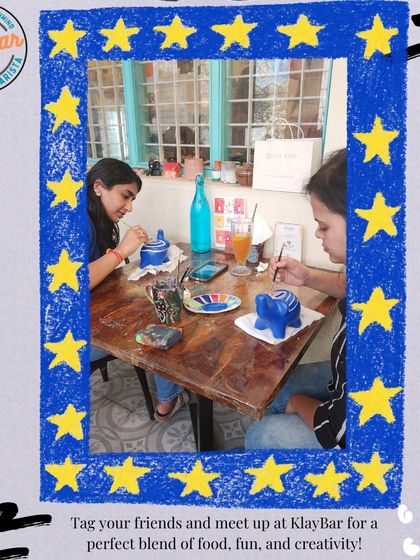 Friends meeting up for a creative session. They've chosen their ceramic pieces and are settling in to paint, chat, and enjoy some quality time together over drinks.