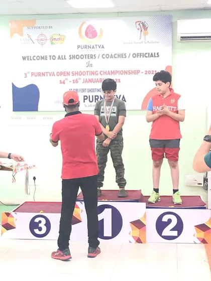 A young shooter receiving his medal on the number one spot at the 3rd Purntva Open Shooting Championship.