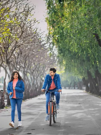 She walks, he rides. A fun, dynamic shot that tells a story of a couple enjoying a beautiful day out, full of energy and playfulness.