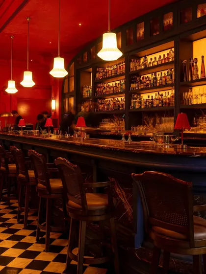 The main bar, a centerpiece of the design. Its form is inspired by traditional Thai architecture, while the extensive back bar and classic stools invite patrons to settle in for the evening.