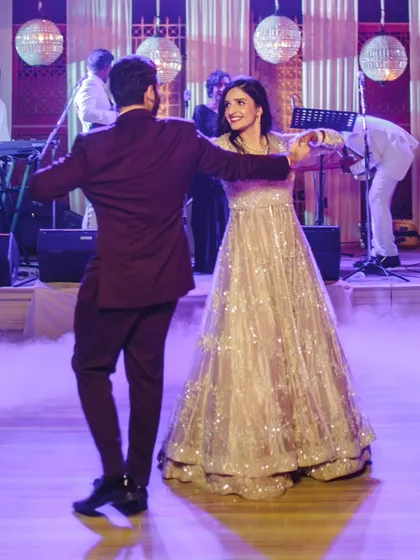 A beautiful twirl on the dance floor. Our choreography incorporates classic dance moves that look elegant and are easy to learn, even with a heavy lehenga.