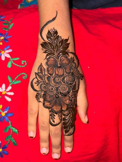 A bold mehendi design with large, striking flowers. The dark fill makes the design really stand out.