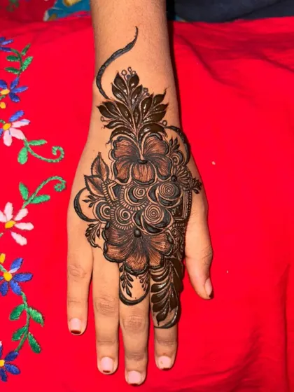 A bold mehendi design with large, striking flowers. The dark fill makes the design really stand out.