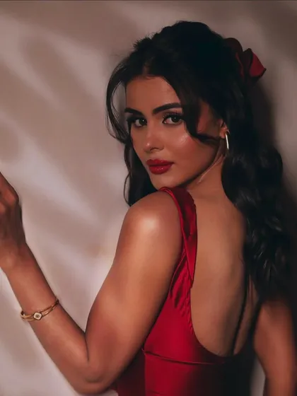 The soft hair and bold makeup create a beautiful contrast, perfect for a celebrity photoshoot.