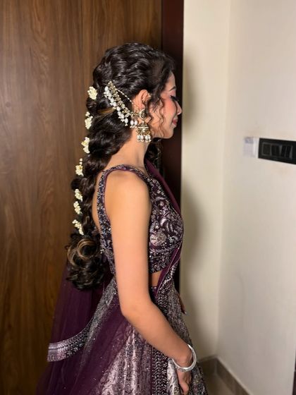 A side view of this intricate braid, showing how the accessories are woven into the hair for a secure and beautiful finish.