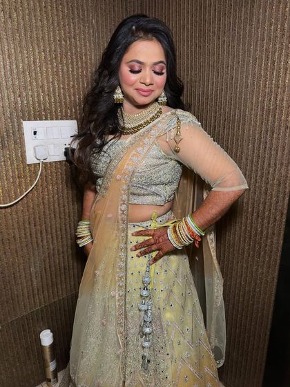 A beautiful party look in a light yellow lehenga. The makeup is soft and shimmery, perfect for an evening function.