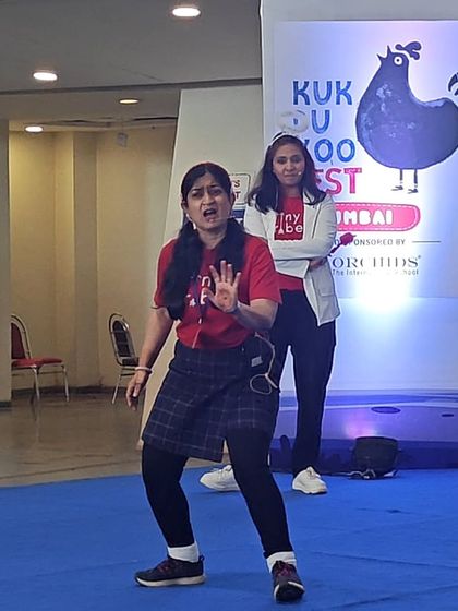Two of our teachers performing a scene on stage. Their expressive faces and gestures tell a story all on their own, capturing the attention of the children sitting in the audience. This is storytelling in its most active form.