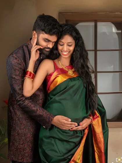 An intimate close-up of the couple. His gentle touch and their happy expressions make this a heartwarming memory of their journey to parenthood.