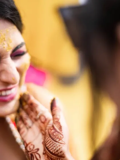 A close-up of the bride's reaction during a playful moment at her haldi.