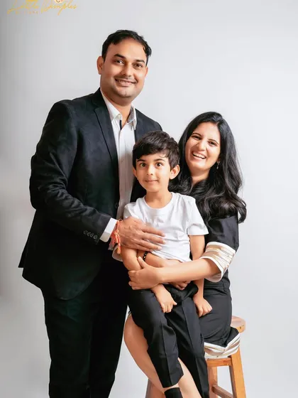 A more formal but still warm family portrait. The clean white background keeps the focus on their happy expressions and connection.