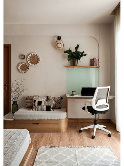 Tucked into a corner of the master bedroom is this cozy reading and study nook. A low daybed with built-in storage is paired with a simple desk, creating the perfect spot to work or relax.