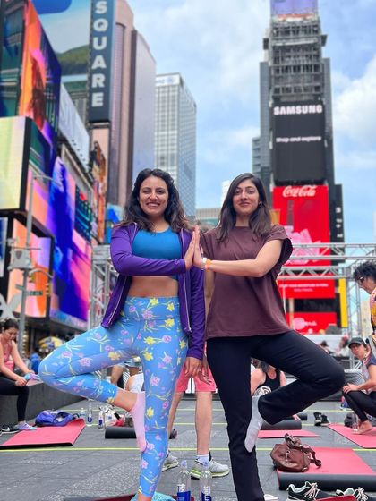 Striking a yoga pose with a friend. It's amazing to share these unique wellness experiences, especially in such an iconic location.