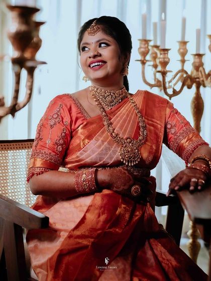The mother-to-be shares a joyful, candid laugh during her indoor maternity session. Her happiness is radiant in this beautiful portrait, surrounded by the soft glow of candles.