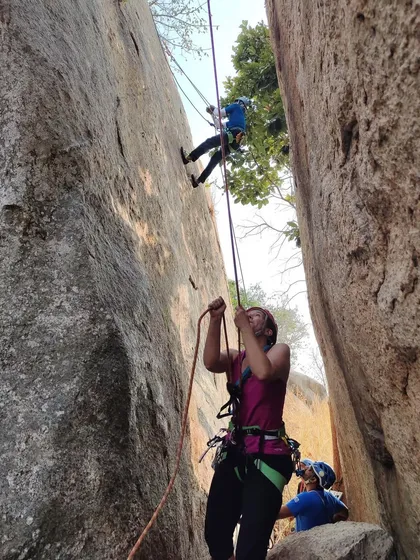 A participant belaying a rappelling climber during our anchoring workshop. Learning to manage ropes and keep your partner safe is a critical skill.