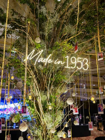 A central feature of the party was this 'memory tree', where we hung photos from the guest of honor's life. The "Made in 1953" neon sign added a fun, celebratory touch.