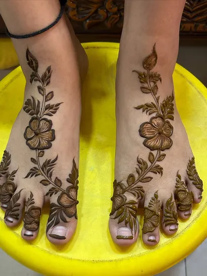 A beautiful floral vine that trails gracefully across the top of the foot and down to the toes.