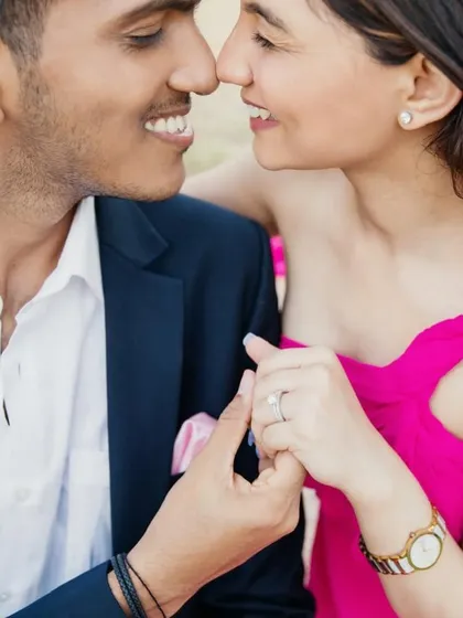 An intimate close-up that captures their connection. Her makeup is barely there, focusing on perfect skin and a natural flush to enhance her beauty.