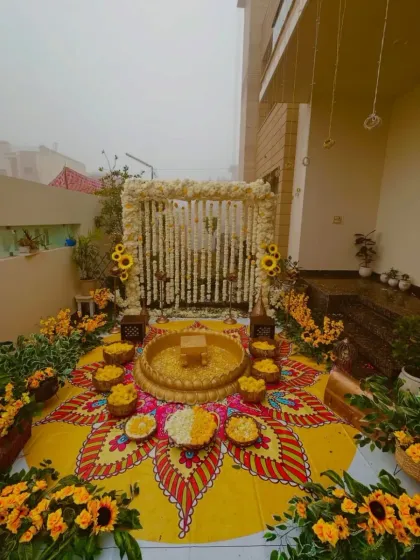 There's nothing like the energy of a Haldi ceremony. This outdoor setup features a hand-painted floor mandala and a canopy of fresh white and yellow flowers, creating a vibrant and picture-perfect space for the celebration.