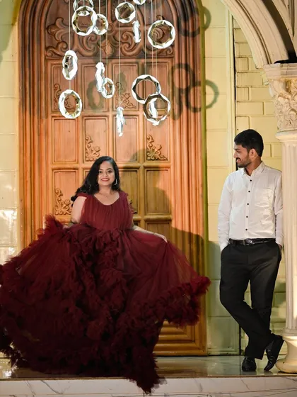 A romantic pose in front of a grand door, with modern hanging lights creating a beautiful, contemporary feel.