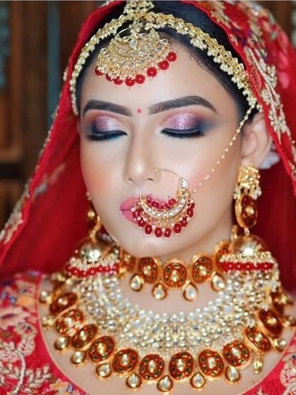 A classic red-on-red bridal look. This Sabyasachi-inspired choker with red stones and pearls is a timeless choice for any bride.