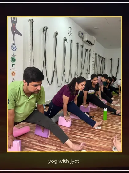Using blocks for support in a wide-legged forward bend (Prasarita Padottanasana) helps students deepen the stretch safely.