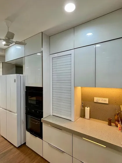 A rolling shutter cabinet next to the appliance unit, perfect for storing small appliances.