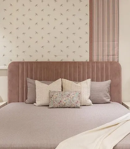 A pink paradise we created for a client's niece. This bedroom features our custom bed with a channeled, dusty rose headboard and matching frame.